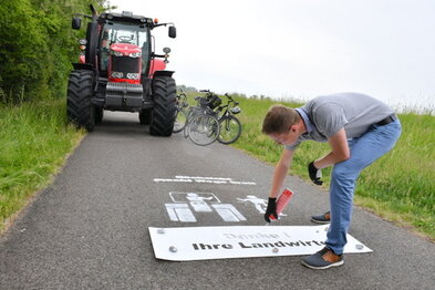 Geschäftsführer des Unstrutradweg e. V. sprüht Slogan auf den Weg