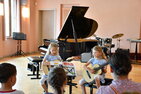 Zwillingsschwestern an der Gitarre beim Konzert der Jüngsten in der Musikschule.